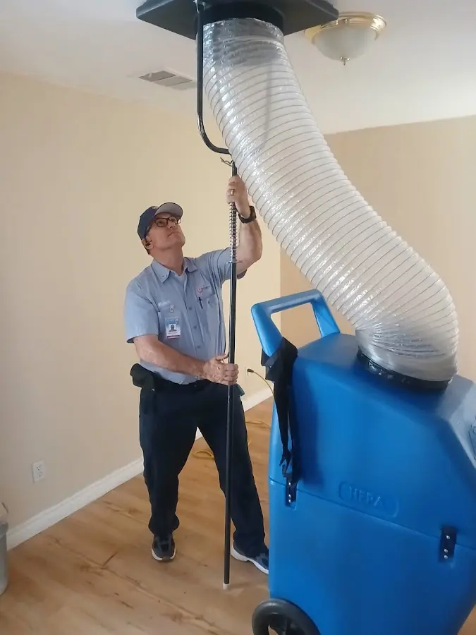 Furnace Tune-Up technician using HEPA equipment in Monticello